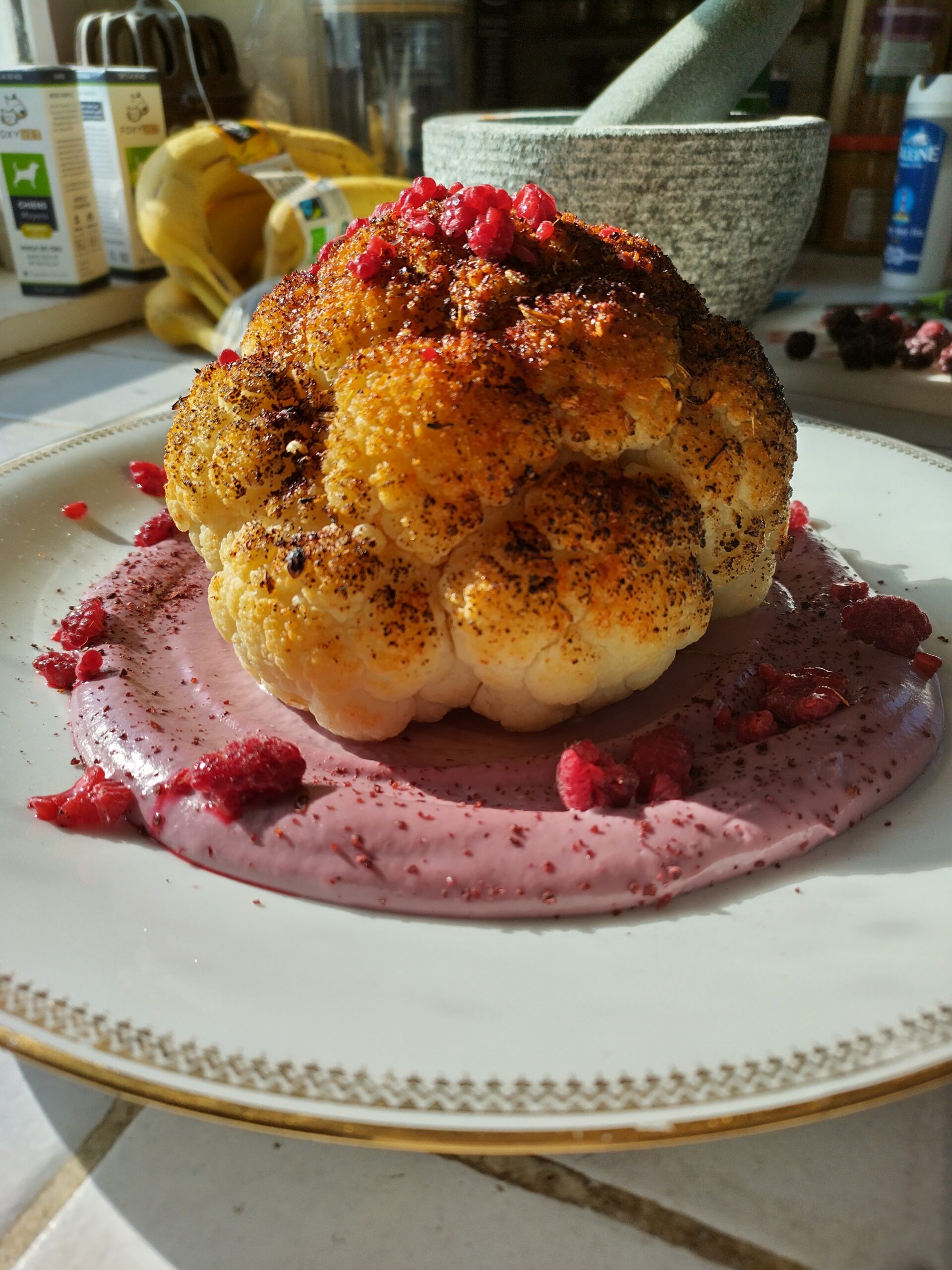 Chou fleur roti avec une sauce rose au tahini et à la framboise.